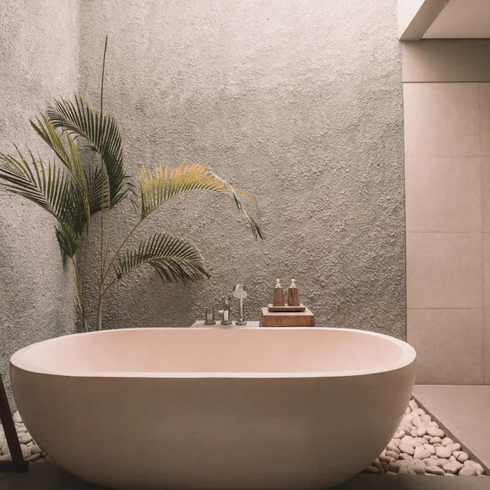 Freestanding bathtub in a serene stone-walled bathroom