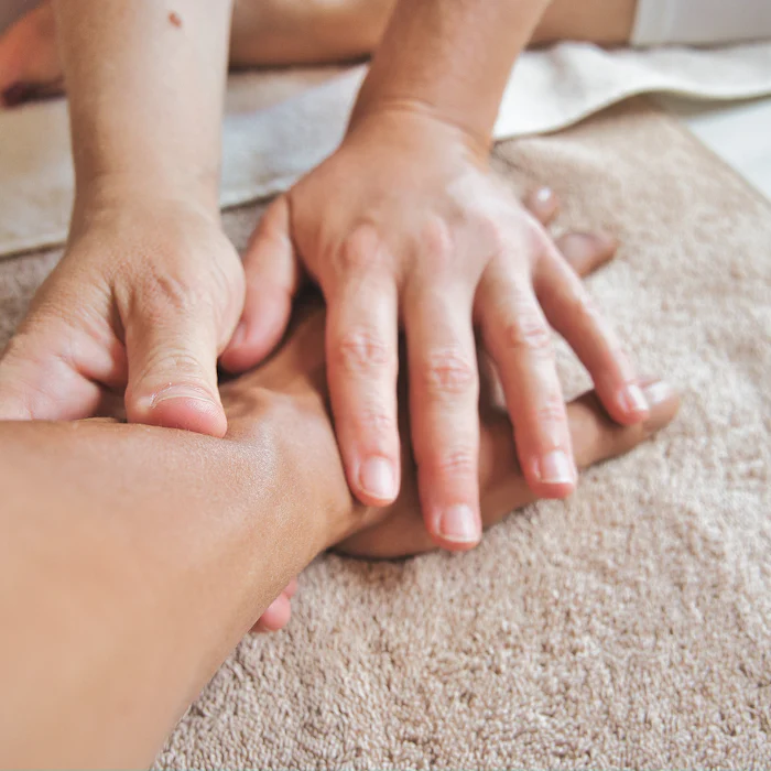 Therapist's hands giving a relaxing hand and arm massage